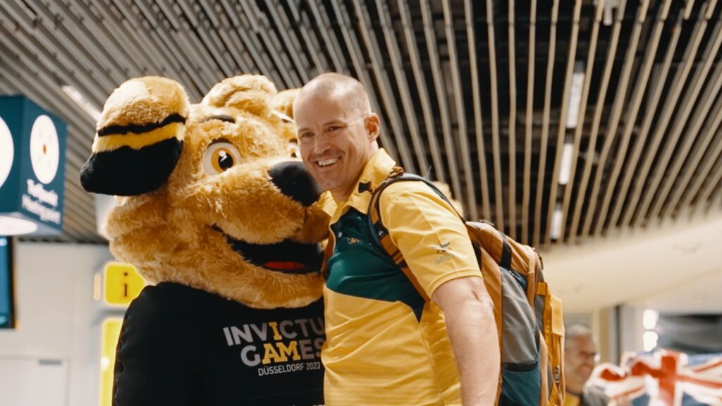 Flight Sergeant Nathan King, Co-Captain Team Australia arriving at Dusseldorf Airport by Buddy the Mascot