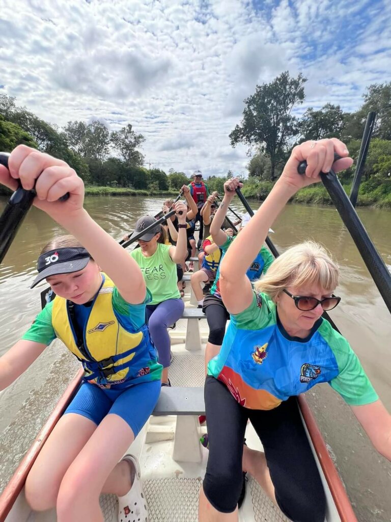 Participants and people volunteering at a Dragon Boating event