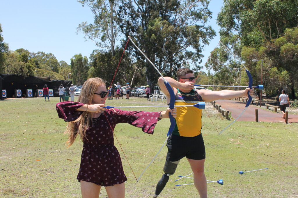Mark Daniels, Invictus Games Alumni, shooting an archery bow at a community event
